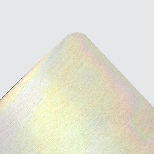 Close-up of sheet metal surface with yellow chromate finish.